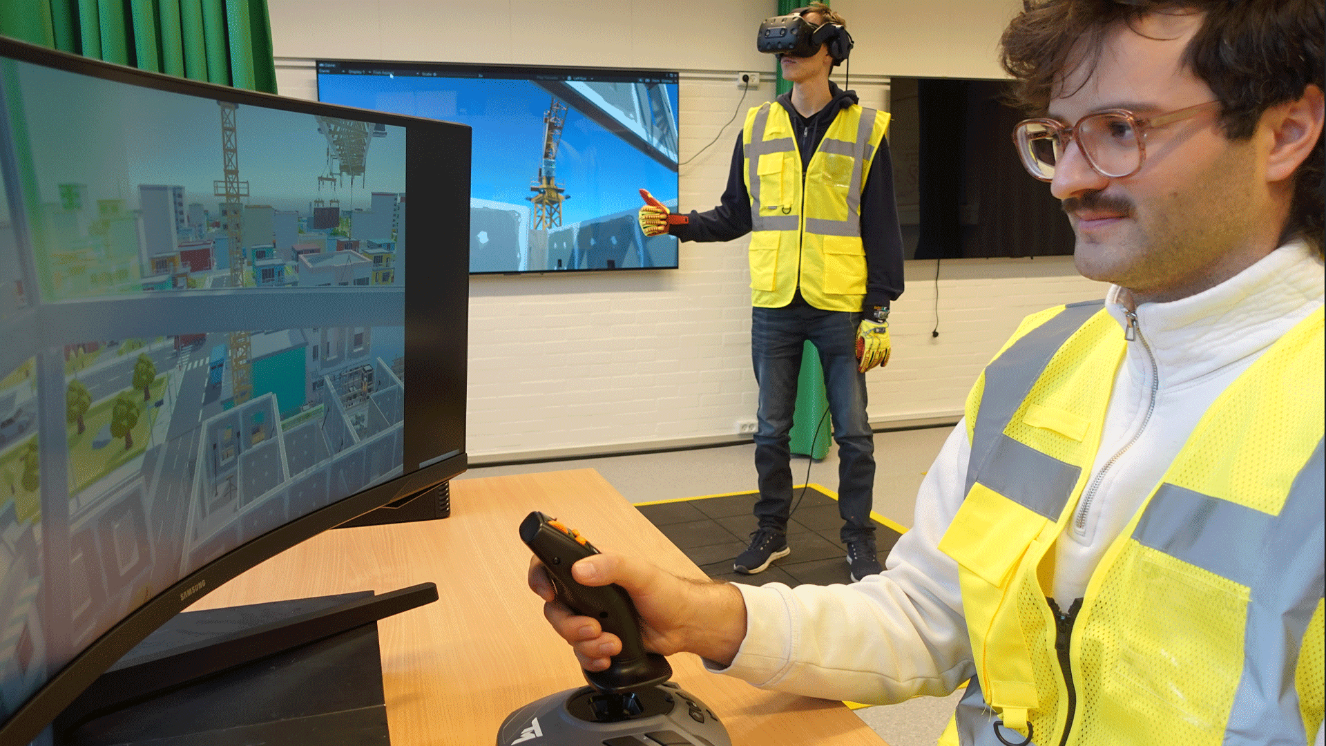 Two men in high vis vests using a virtual reality training programme aimed at improving safety in construction workplaces. Photo: Jochen Teizer